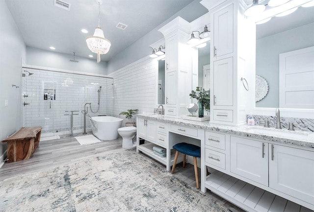 636 Villa Dr, Crystal Beach, TX 77650 - full bathroom featuring double vanity, a soaking tub, visible vents, a stall shower, and a sink