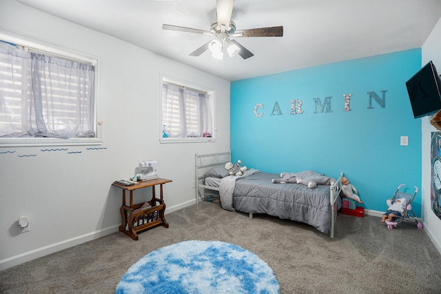 carpeted bedroom featuring ceiling fan and baseboards