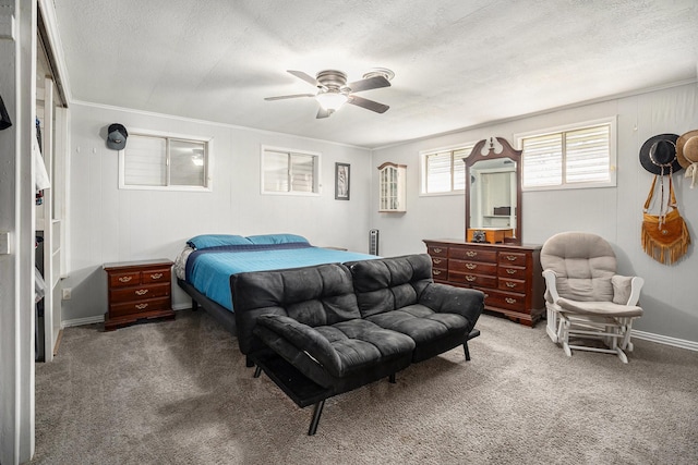 bedroom with ceiling fan, a textured ceiling, and carpet flooring