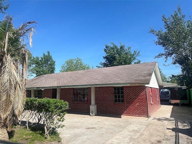 view of front of home with concrete driveway and brick siding