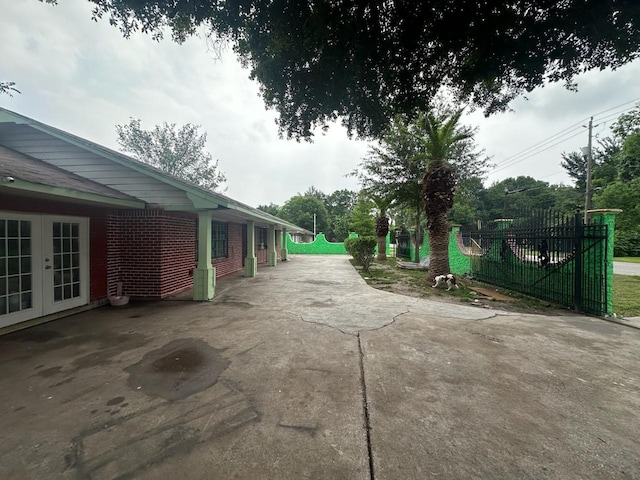 exterior space featuring french doors and fence