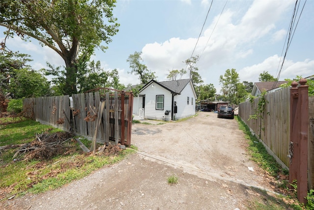 view of yard with driveway, a gate, and fence