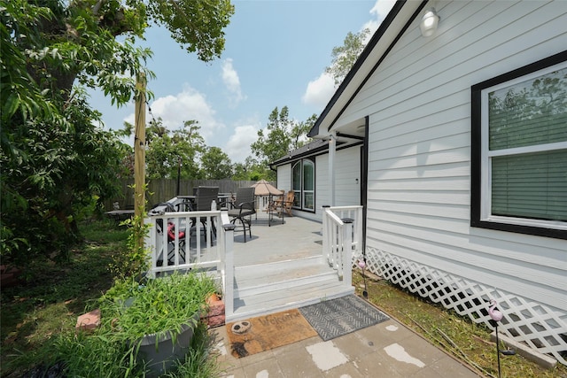 deck with fence and outdoor dining area