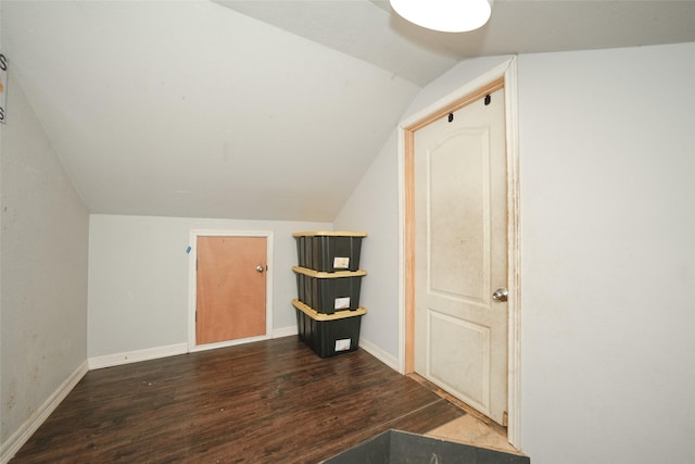 additional living space with baseboards, vaulted ceiling, and wood finished floors