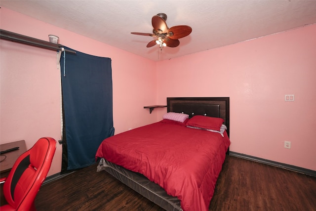 bedroom with a textured ceiling, wood finished floors, and a ceiling fan