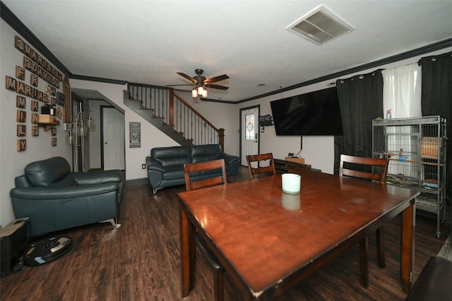 dining area featuring wood finished floors, visible vents, a ceiling fan, ornamental molding, and stairway