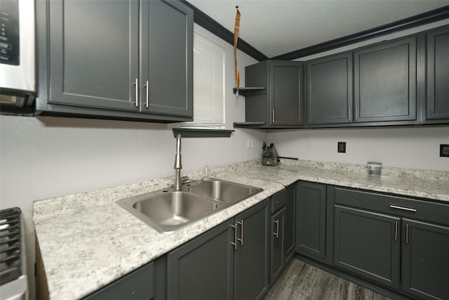 kitchen featuring dark wood finished floors, open shelves, light countertops, a sink, and a textured ceiling