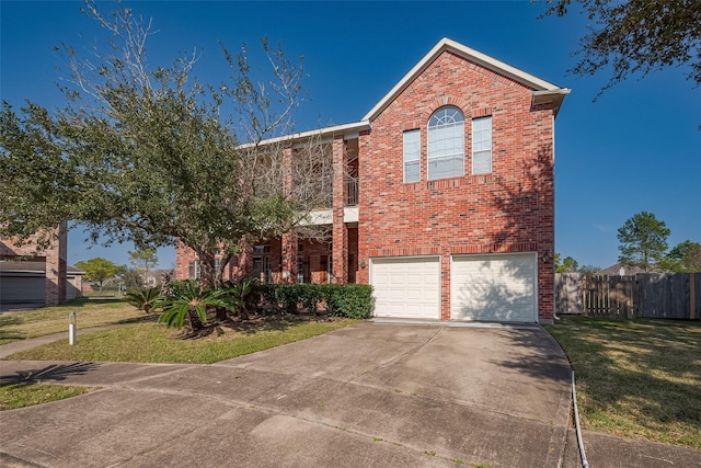 traditional-style house with a front yard, fence, concrete driveway, and brick siding