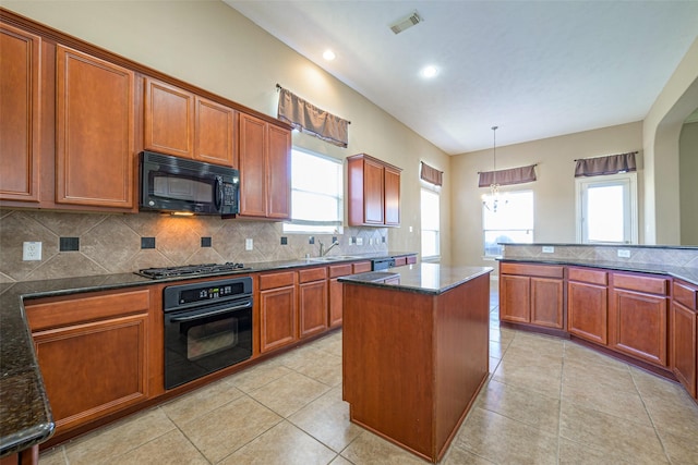 kitchen featuring black appliances, light tile patterned floors, brown cabinets, and backsplash