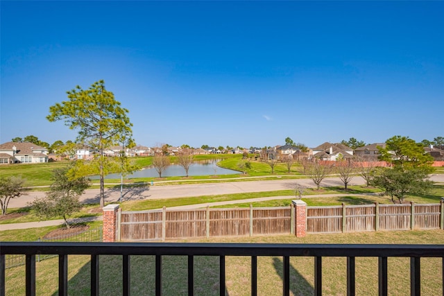 balcony featuring a water view and a residential view