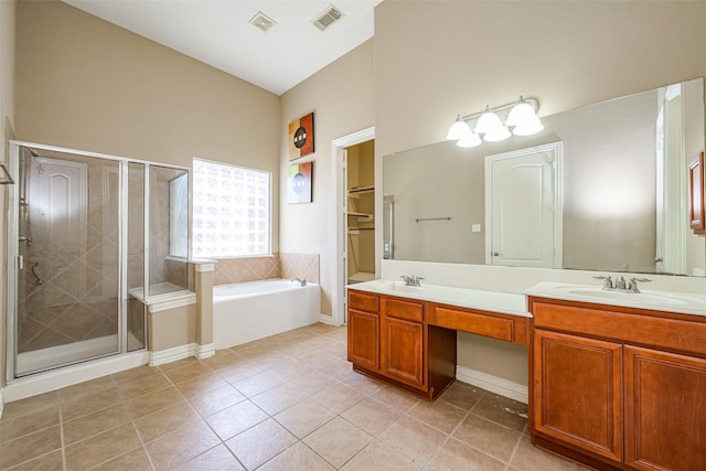 bathroom with a sink, visible vents, a shower stall, tile patterned floors, and double vanity