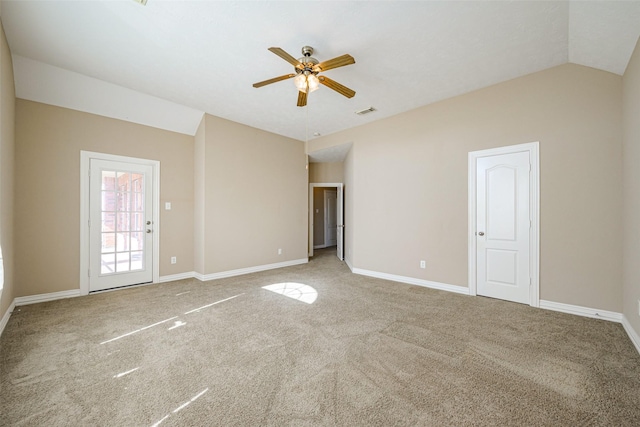 unfurnished room featuring lofted ceiling, baseboards, visible vents, and carpet flooring