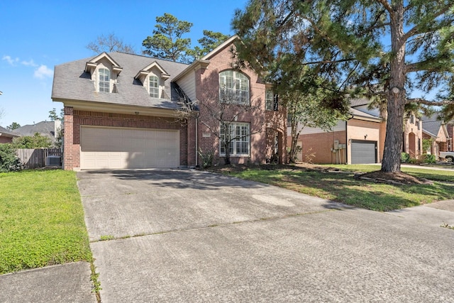 view of front of house with a garage, a front lawn, concrete driveway, and brick siding