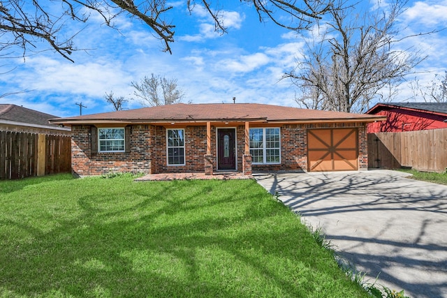 ranch-style home featuring a garage, a front lawn, concrete driveway, and brick siding