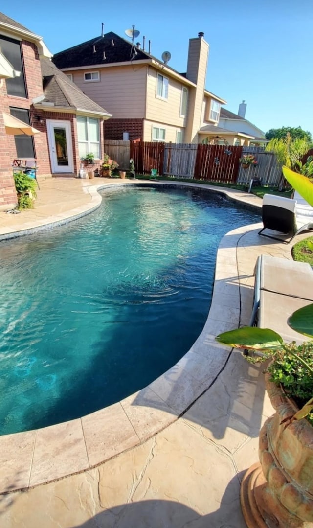 view of swimming pool with a fenced in pool, fence, and a patio