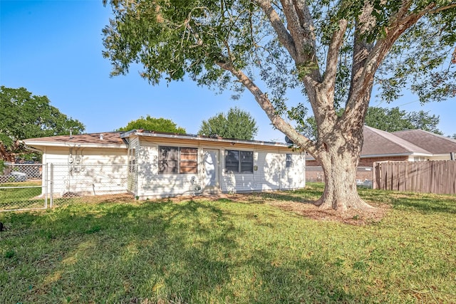 view of front of house with a front yard and fence