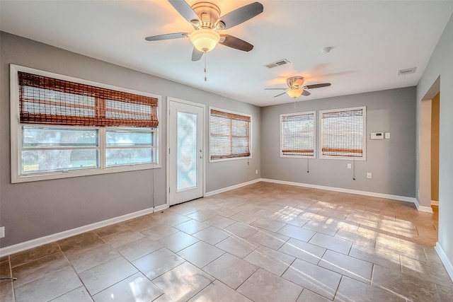 interior space featuring visible vents, baseboards, and ceiling fan