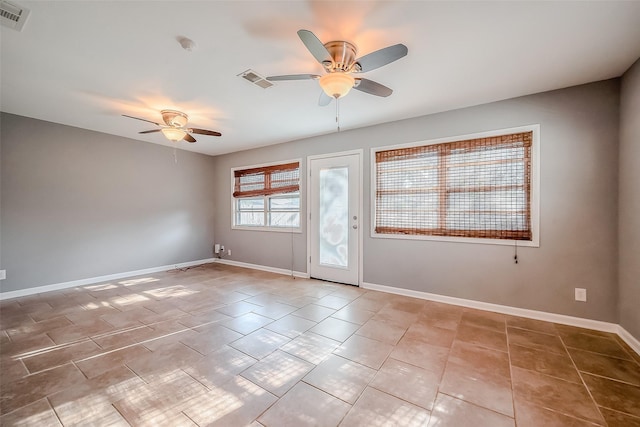 unfurnished room featuring a ceiling fan, visible vents, baseboards, and tile patterned floors