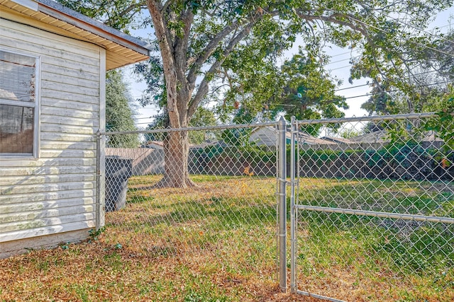 view of yard featuring fence and a gate