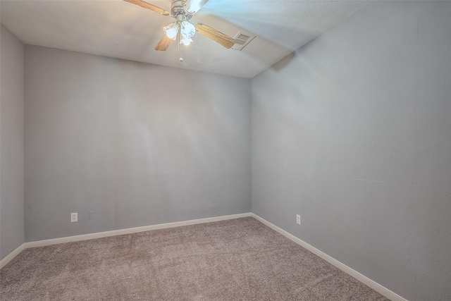 unfurnished room featuring carpet floors, ceiling fan, visible vents, and baseboards