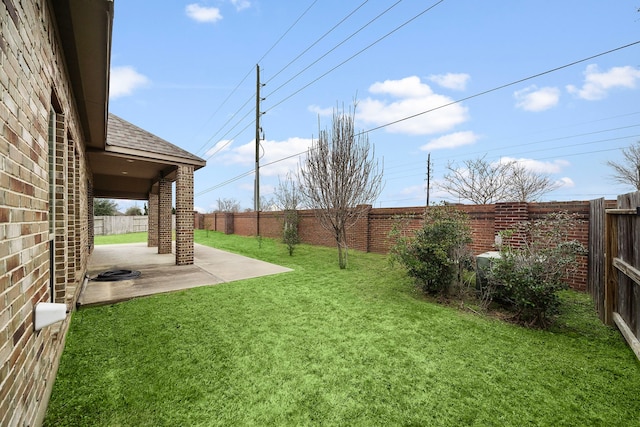 view of yard with a fenced backyard and a patio