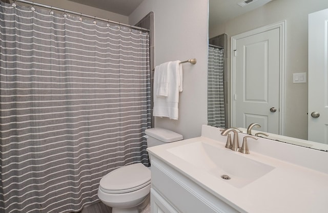 bathroom with toilet, visible vents, and vanity