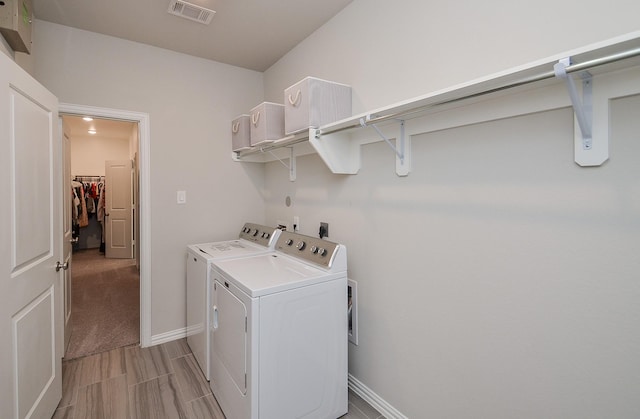 laundry room featuring laundry area, baseboards, visible vents, and washing machine and clothes dryer