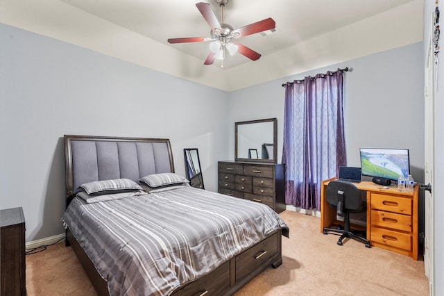 bedroom with light carpet, ceiling fan, and baseboards