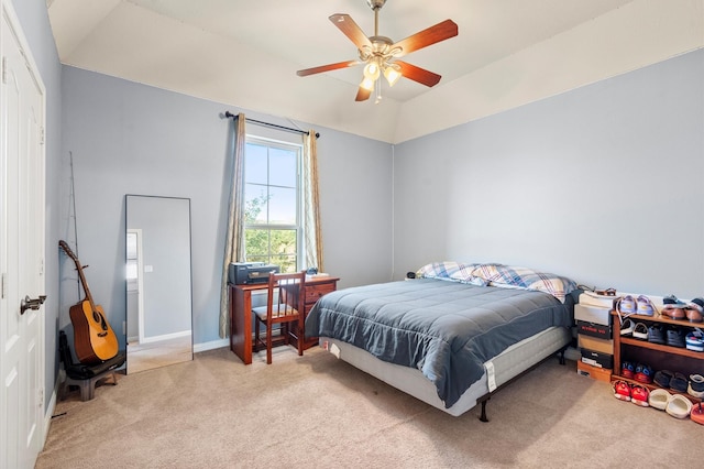 bedroom featuring lofted ceiling, baseboards, a ceiling fan, and light colored carpet