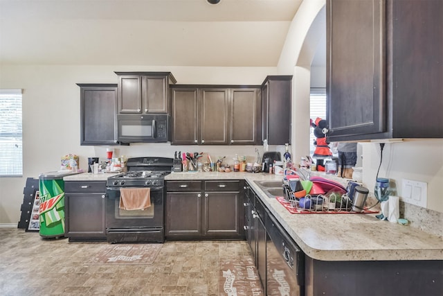 11430 Barbican Ct, Conroe, TX 77304 - kitchen with black appliances, light countertops, and dark brown cabinetry