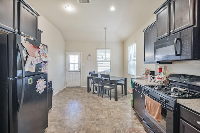 11430 Barbican Ct, Conroe, TX 77304 - kitchen with lofted ceiling, a chandelier, visible vents, baseboards, and black appliances