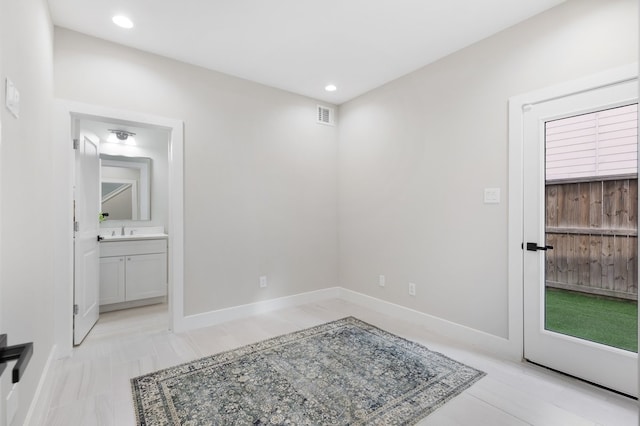 interior space with recessed lighting, visible vents, a sink, and baseboards