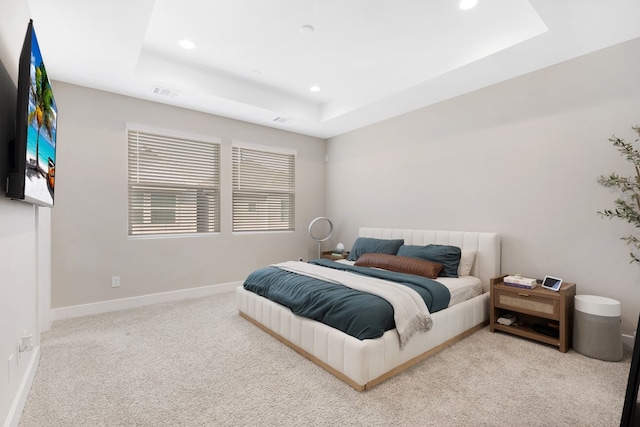 bedroom featuring recessed lighting, a raised ceiling, light colored carpet, visible vents, and baseboards