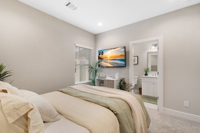 bedroom with recessed lighting, light colored carpet, visible vents, connected bathroom, and baseboards