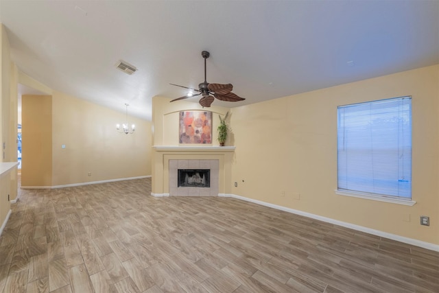 unfurnished living room with visible vents, baseboards, lofted ceiling, light wood-type flooring, and a fireplace