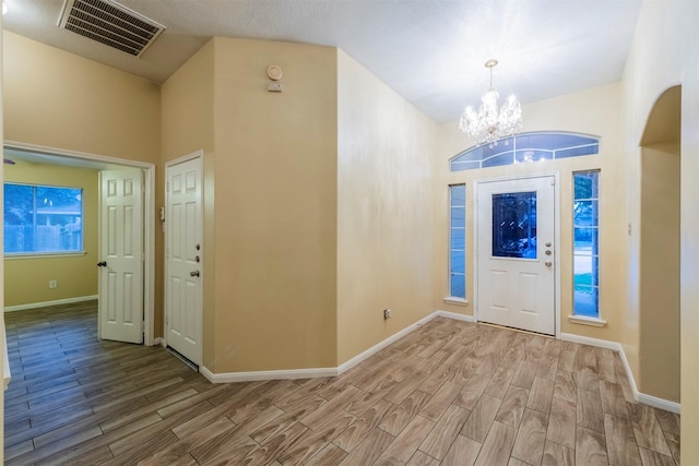 entrance foyer featuring wood finished floors, visible vents, and baseboards