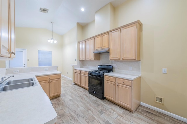 kitchen with gas stove, a sink, under cabinet range hood, and light brown cabinetry