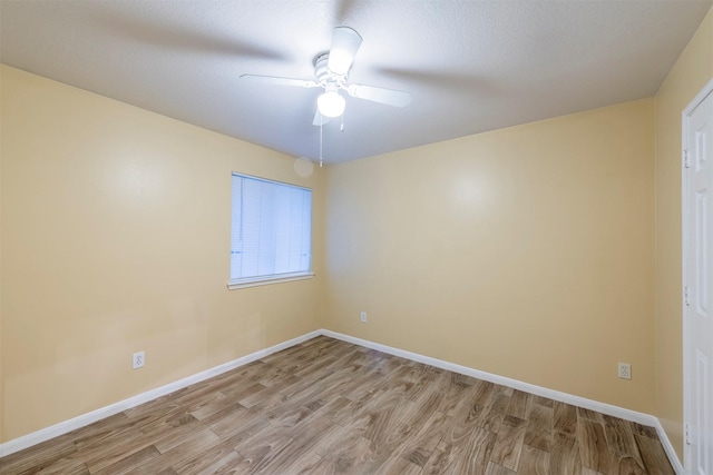 unfurnished room featuring light wood finished floors, ceiling fan, and baseboards