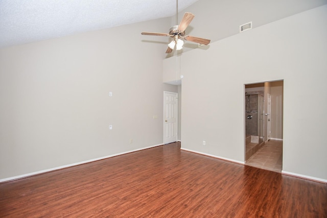 spare room with a ceiling fan, visible vents, baseboards, and wood finished floors