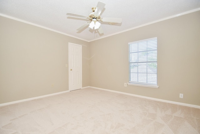 unfurnished room with light carpet, baseboards, ceiling fan, a textured ceiling, and crown molding