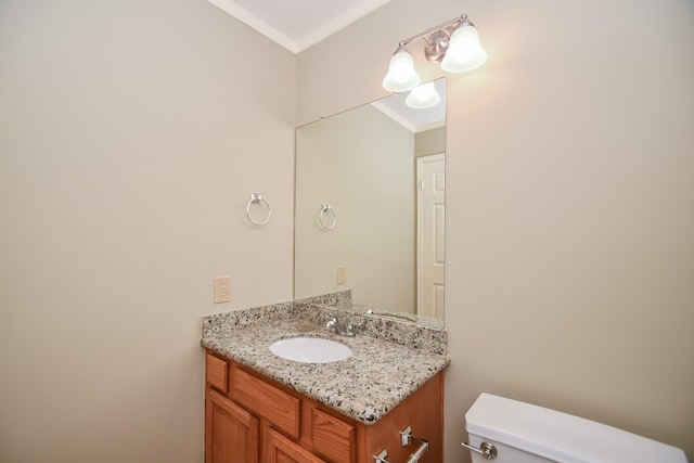 half bath featuring toilet, ornamental molding, and vanity