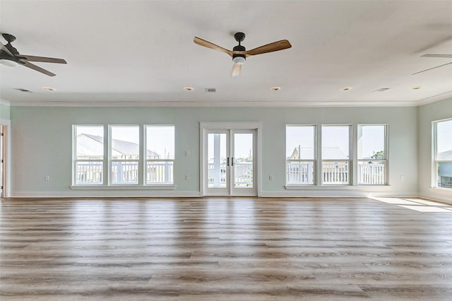 unfurnished living room featuring wood finished floors, visible vents, baseboards, a ceiling fan, and ornamental molding