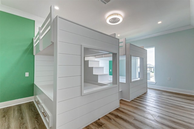 interior space with baseboards, wood finished floors, and recessed lighting