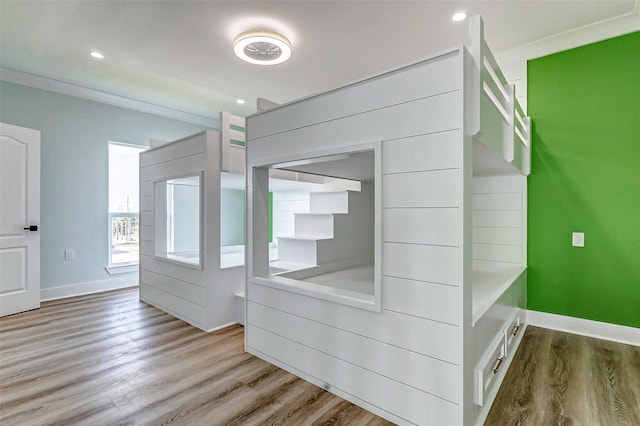 unfurnished bedroom featuring recessed lighting, baseboards, and wood finished floors