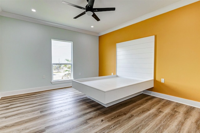 empty room featuring ornamental molding, recessed lighting, baseboards, and wood finished floors