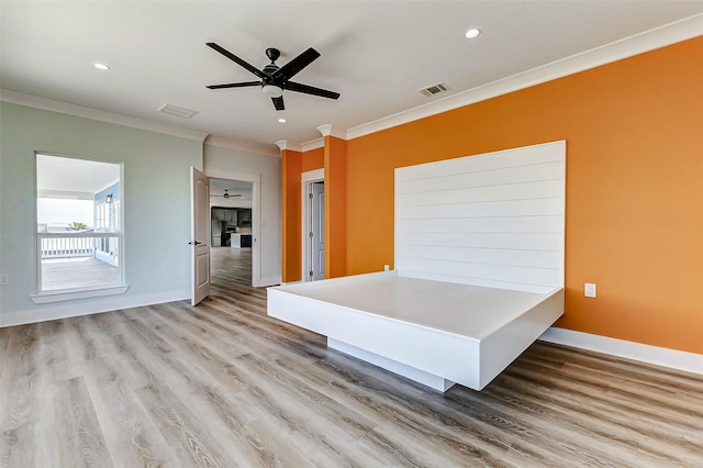 interior space with visible vents, crown molding, baseboards, and wood finished floors