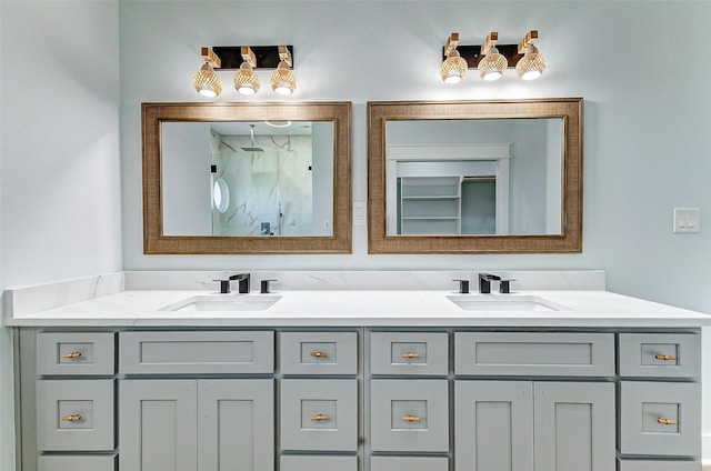 full bathroom featuring double vanity, a walk in shower, and a sink