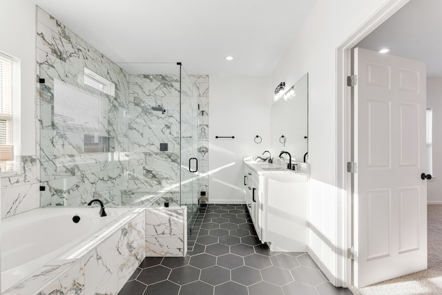 bathroom featuring a marble finish shower, plenty of natural light, a bath, and vanity