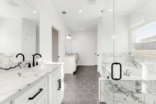 full bath featuring a marble finish shower, visible vents, and a sink