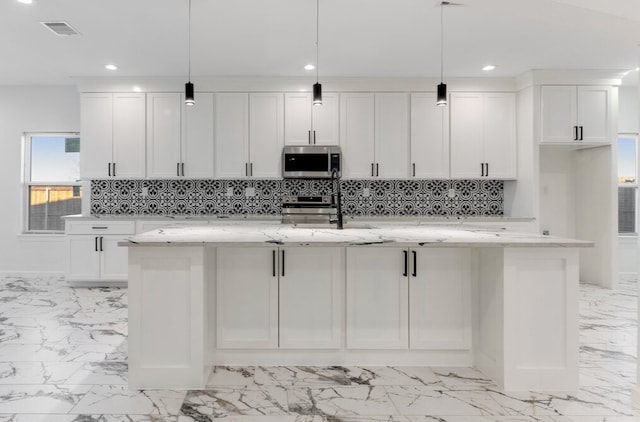 kitchen with visible vents, marble finish floor, appliances with stainless steel finishes, and white cabinets